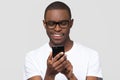 Happy young african man using smartphone gadget social media apps