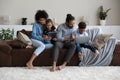 Happy African parents and gen Z kids sitting on couch Royalty Free Stock Photo