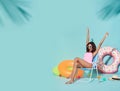 Happy young african woman dressed in swimwear enjoying their summer vacation getaway in blue banner background with copy space Royalty Free Stock Photo