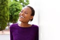 Happy young african woman leaning on wall Royalty Free Stock Photo