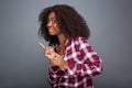 Happy young african woman pointing finger at copy space on gray background Royalty Free Stock Photo