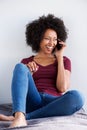 Happy young african woman relaxing and talking on mobile phone Royalty Free Stock Photo