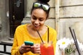 Happy young african woman sitting at cafe Royalty Free Stock Photo