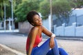 Happy young african woman sitting outdoors Royalty Free Stock Photo