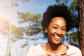 Happy young african woman standing outdoors and smiling Royalty Free Stock Photo