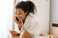 Happy young african woman talking on cell phone Royalty Free Stock Photo