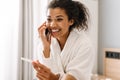 Happy young african woman talking on cell phone Royalty Free Stock Photo