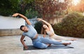Happy young arab and african american women athletes in sportswear practice yoga, stretching arms and body