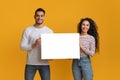 Happy Young Arab Spouses Holding White Blank Placard In Hands Royalty Free Stock Photo