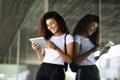 Happy young Arab woman using digital tablet in business background.