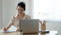 Happy young asia business woman entrepreneur using computer looking at screen working in internet sit at office desk, smiling Royalty Free Stock Photo