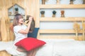 Happy young asian beautiful caucasian woman kissing and holding a  cat. Playing with pet at home. Love, coziness, leisure, Royalty Free Stock Photo