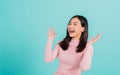 Happy young Asian beautiful woman smiling wear silicone orthodontic retainers on teeth surprised she is excited screaming and rais Royalty Free Stock Photo