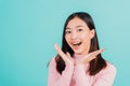 Happy young Asian beautiful woman smiling wear silicone orthodontic retainers on teeth surprised she is excited screaming and rais Royalty Free Stock Photo