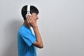 Happy young Asian boy teenager listening to music with his headphones with a copy space Royalty Free Stock Photo