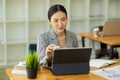 Happy young asian business woman entrepreneur using digital tablet Royalty Free Stock Photo