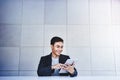 Happy Young Asian Businessman Working on Digital Tablet Royalty Free Stock Photo