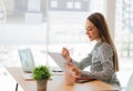 Happy young asian businesswoman celebrating success with arms raised in front of laptop with excitement at office Royalty Free Stock Photo