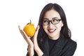 Happy young asian corporate executive holding an ugli fruit