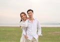 Happy young Asian couple in bride and groom clothing