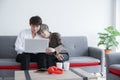 Happy young Asian couple gay lovers sitting snuggle and using laptop computer together on sofa at living room Royalty Free Stock Photo