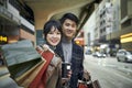 Happy young asian couple waiting for bus in modern city Royalty Free Stock Photo