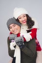 Happy young asian couple wearing knitted warm scarf, over gray b Royalty Free Stock Photo