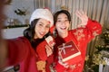 Happy young Asian couple women enjoying Christmas party in home Royalty Free Stock Photo