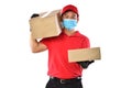 Happy young Asian delivery man in red uniform, medical face mask, protective gloves carry cardboard box in hands isolated on white Royalty Free Stock Photo