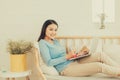 Happy young asian entrepreneur working with a laptop at home. Royalty Free Stock Photo