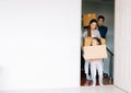 Happy young Asian family with cute daughter carrying boxes into the a new home on moving day. Moving day concept, mortgage and Royalty Free Stock Photo