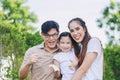 Happy young Asian family playing together at home outdoors parent with one child leisure lifestyle Royalty Free Stock Photo