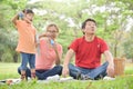 Asian family are blowing soap bubbles together. Royalty Free Stock Photo