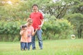 Asian family are blowing soap bubbles together. Royalty Free Stock Photo