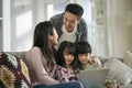 happy young asian family with two children using notebook computer together Royalty Free Stock Photo