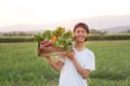 Happy young asian farmer carrying fresh product of vegetable basket Royalty Free Stock Photo