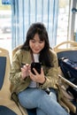 A happy young Asian female enjoying chatting with her friends while on a public bus Royalty Free Stock Photo