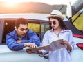 Happy young Asian friend looking to the map traveling by the eco car Royalty Free Stock Photo