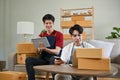 A happy Asian gay couple, online shop owners, working at home together. online business Royalty Free Stock Photo