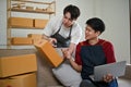 A happy young Asian gay couple is preparing shipping products and working at home together Royalty Free Stock Photo