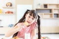 happy young asian girl eat milk cookie biscuit with dairy fresh milk for breakfast in morning before go to study at school