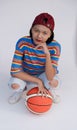 Happy young asian girl palying basketball with pastel background