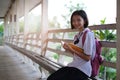 Happy young asian girl reading book at school Royalty Free Stock Photo