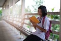 Happy young asian girl reading book at school Royalty Free Stock Photo