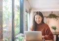 Young Asian girl celebrate success or happy pose with laptop Royalty Free Stock Photo