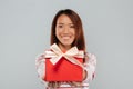 Happy young asian lady holding gift. Royalty Free Stock Photo