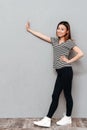 Happy young asian lady over grey wall make stop gesture Royalty Free Stock Photo