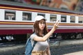 Happy young Asian lady tourist with model airplane at train station. Travel lifestyle concept Royalty Free Stock Photo