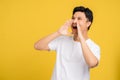 Happy young asian man announces information. He is shouting Royalty Free Stock Photo