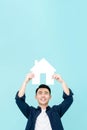Happy young Asian man holding house sign Royalty Free Stock Photo